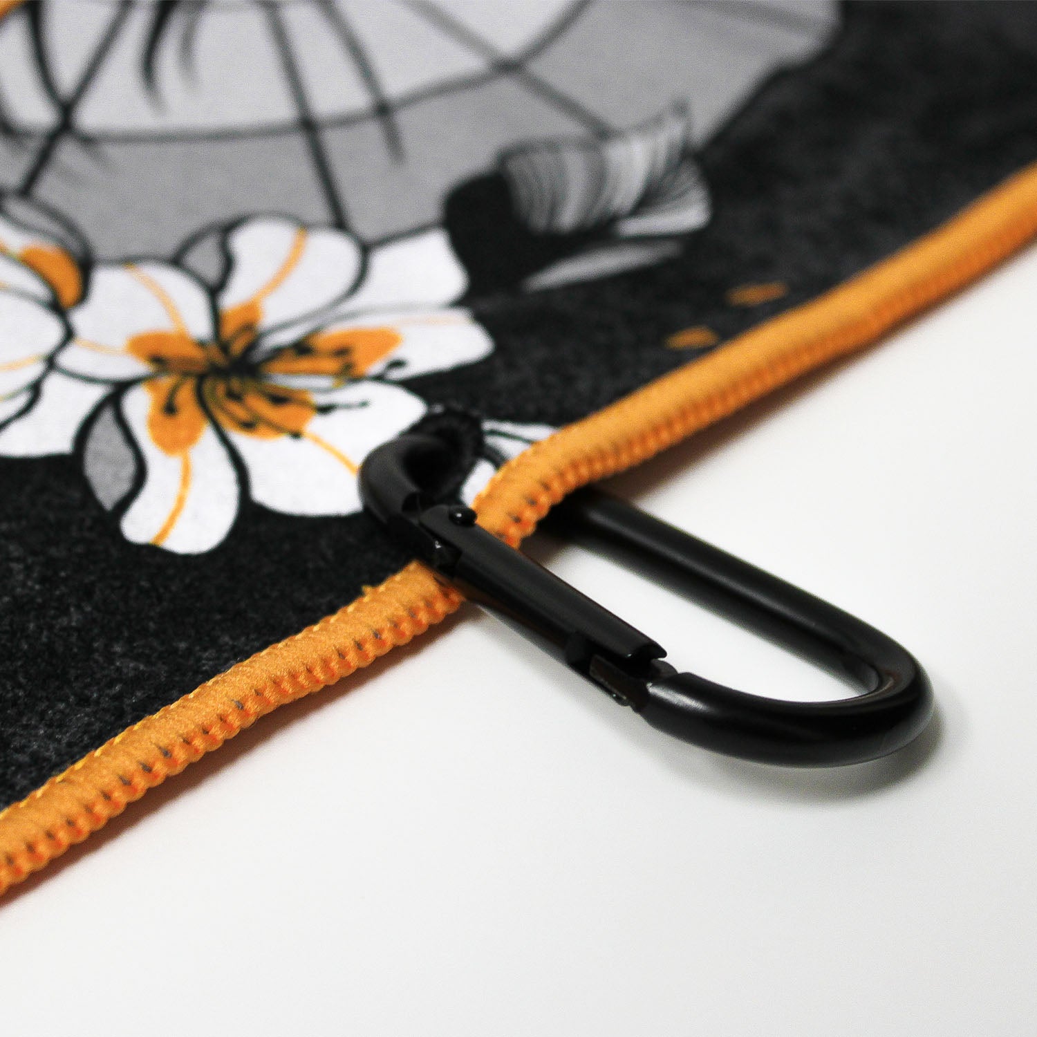 Close up of Utility Towel black carabiner clip with 'RokFit X Blondie' graphic