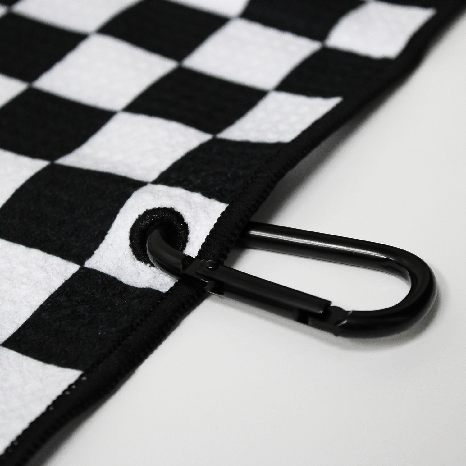 Close up of Utility Towel black carabiner clip with 'Checker' graphic