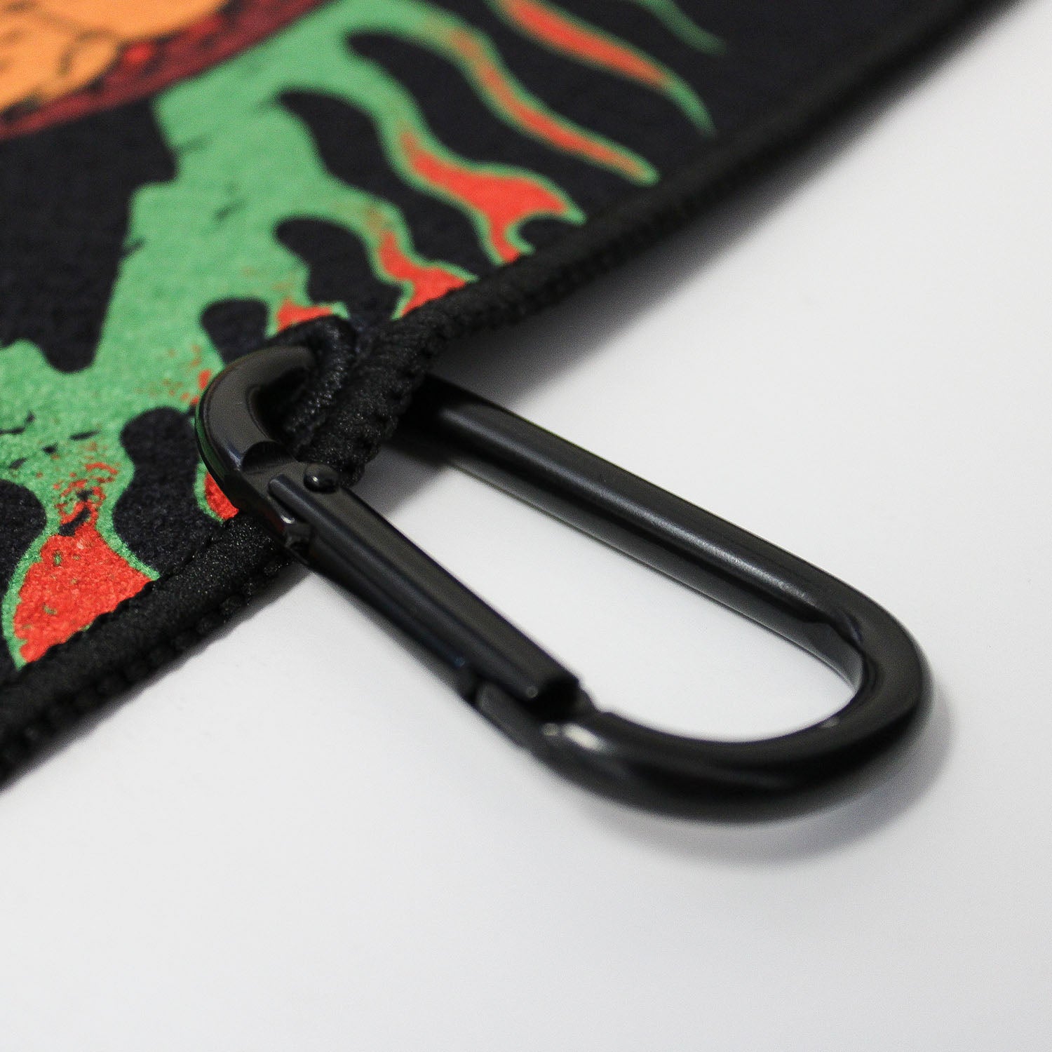 Close up of Utility Towel black carabiner clip with 'Face The Fury' graphic