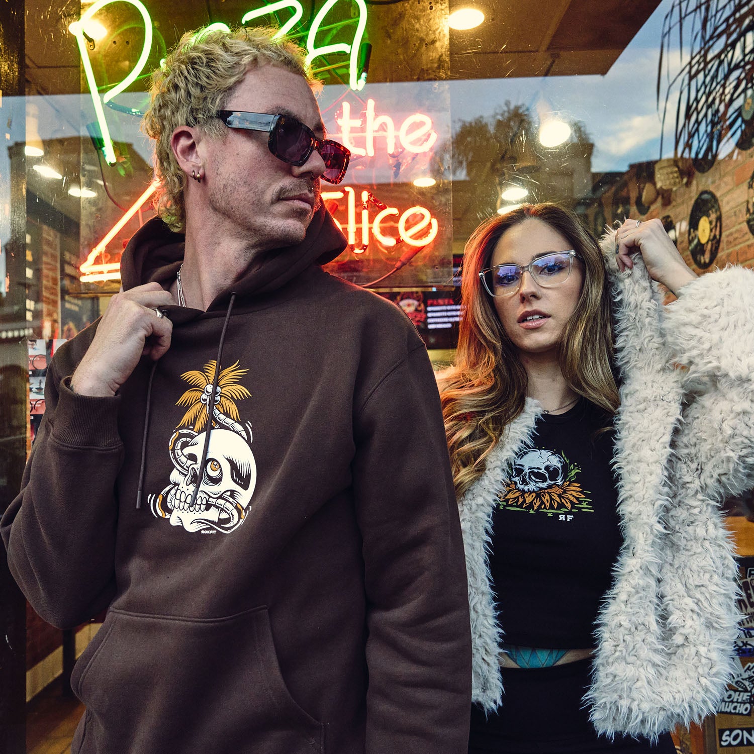Male and Female models outdoors wearing hoody with 'Mental Vacation' graphic