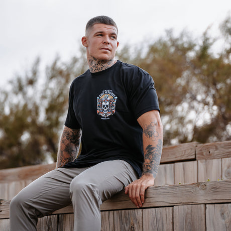 Male model outdoors wearing unisex Active Tee with 'Endure The Storm' graphic