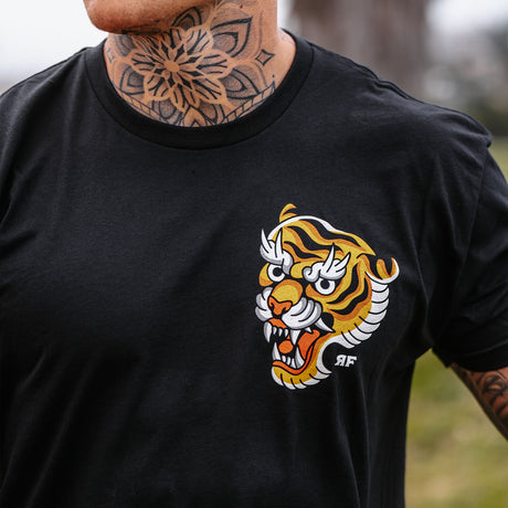 Male model outdoors wearing unisex Active Tee with 'Make Excuses or Make Progress' graphic