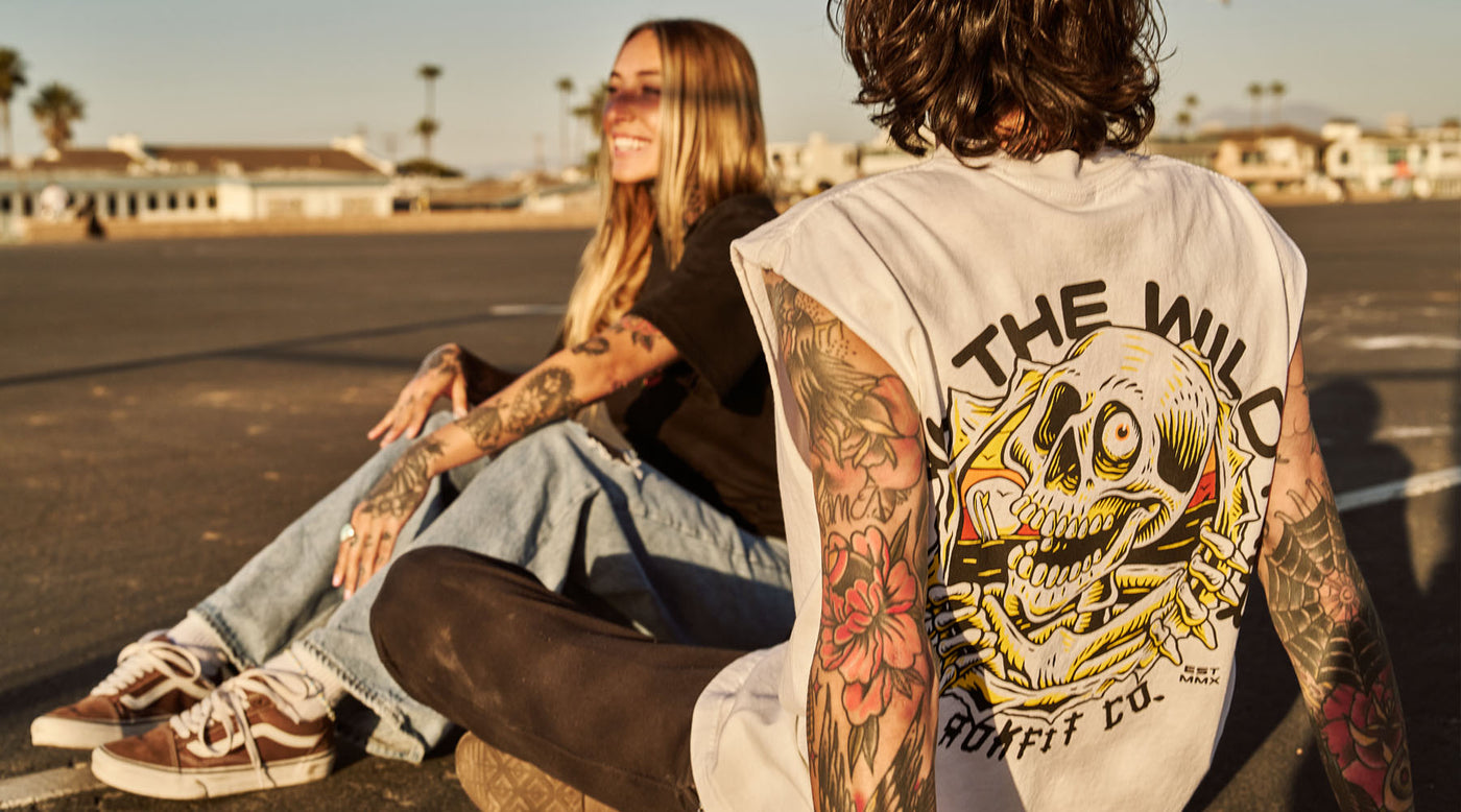 Male model outdoors wearing a sleeveless street tee with 'Drink The Wild Air' graphic